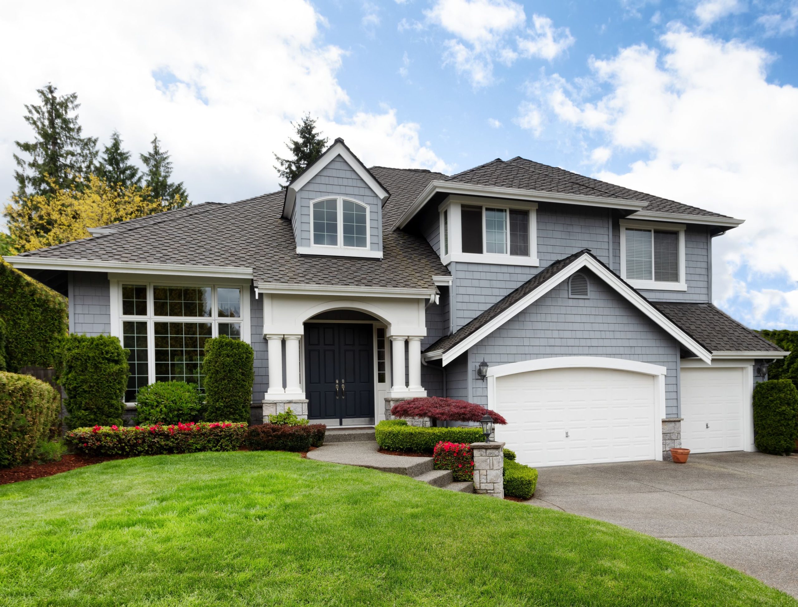 A large two story home with landscaping